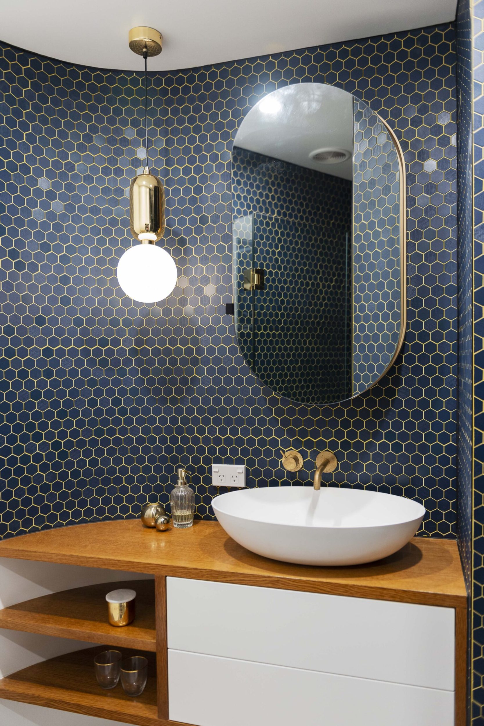 Ensuite with blue honeycomb tile and gold pendant light
