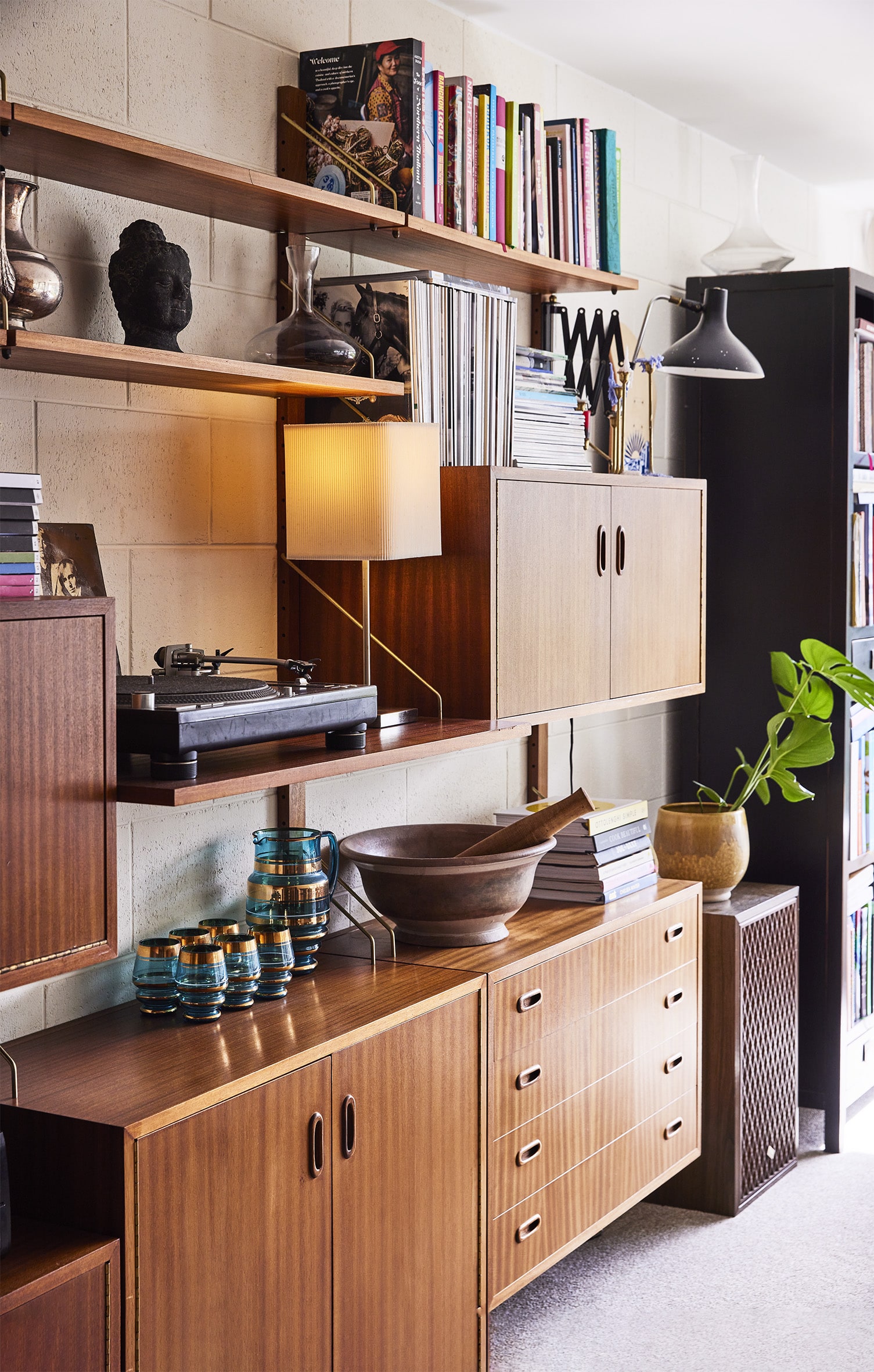 Brown cabinets and shelves against a white bricked wall