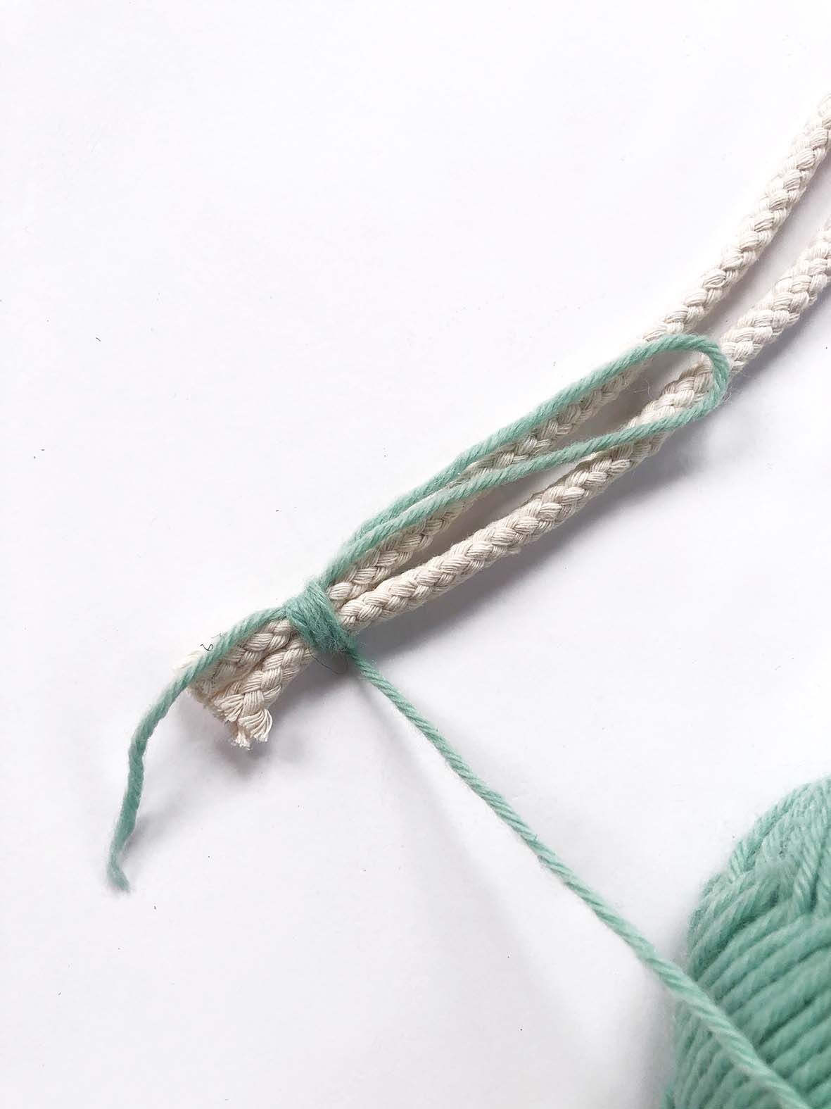 A piece of wool tying two cords together