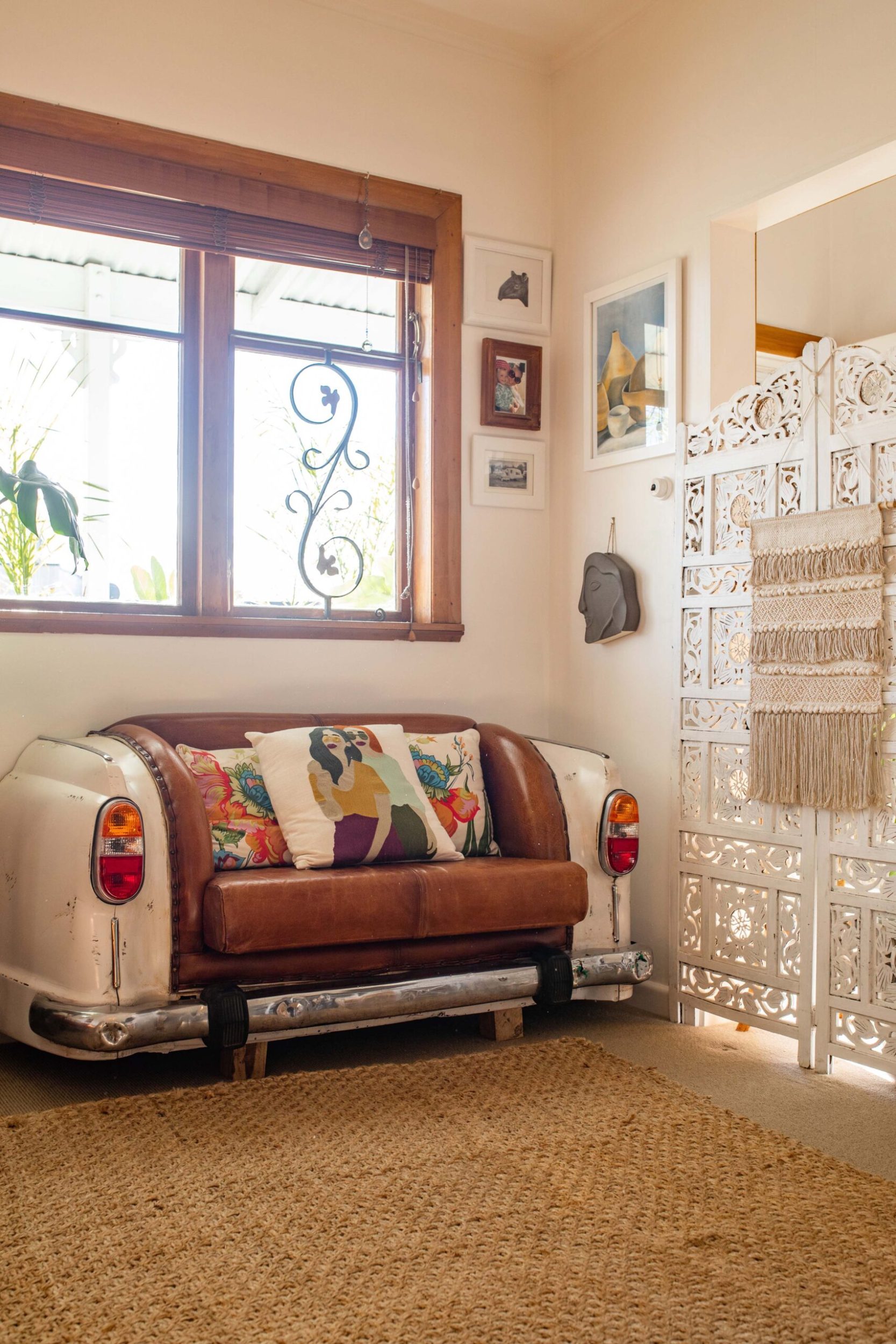 A car shaped sofa in the corner of a living room