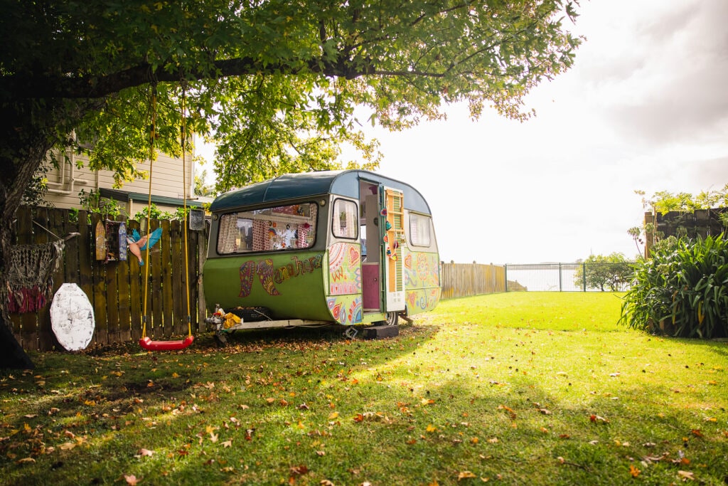 A retro themed painted caravan on a grass yard