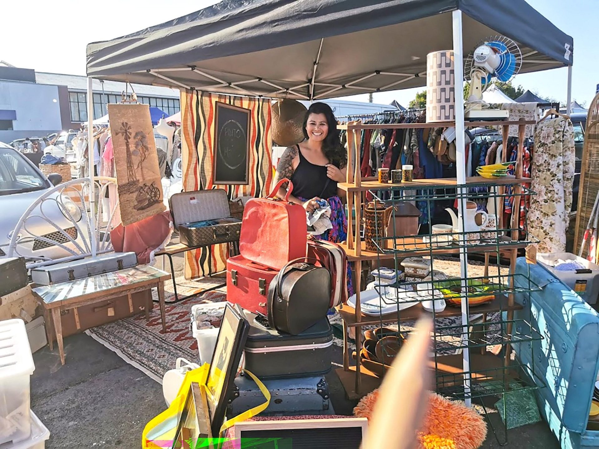 Woman smiling while standing at stall at Central Flea Market