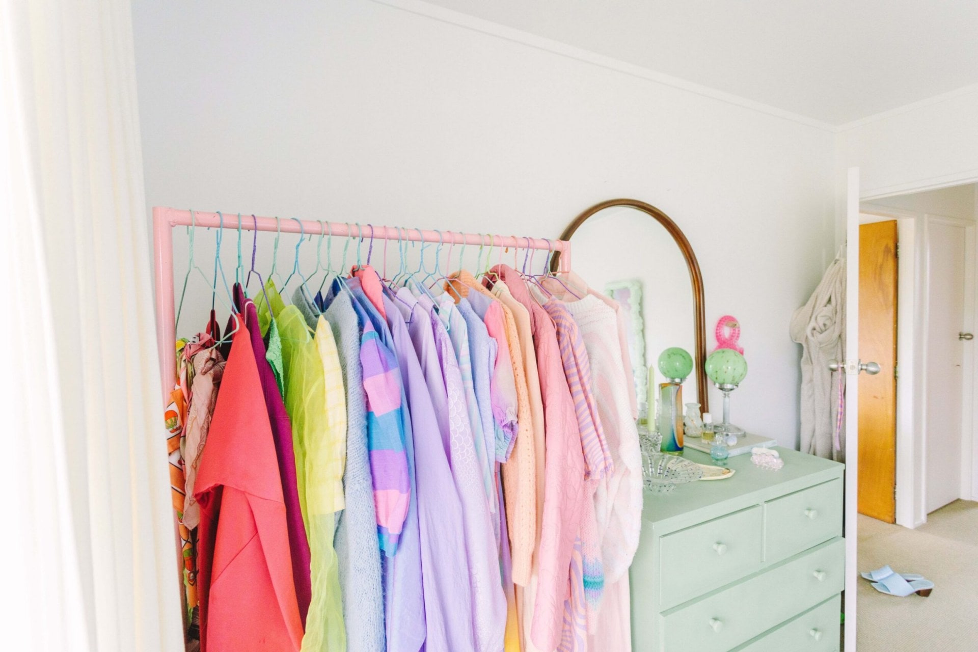 Clothing rack filled with pastel clothes