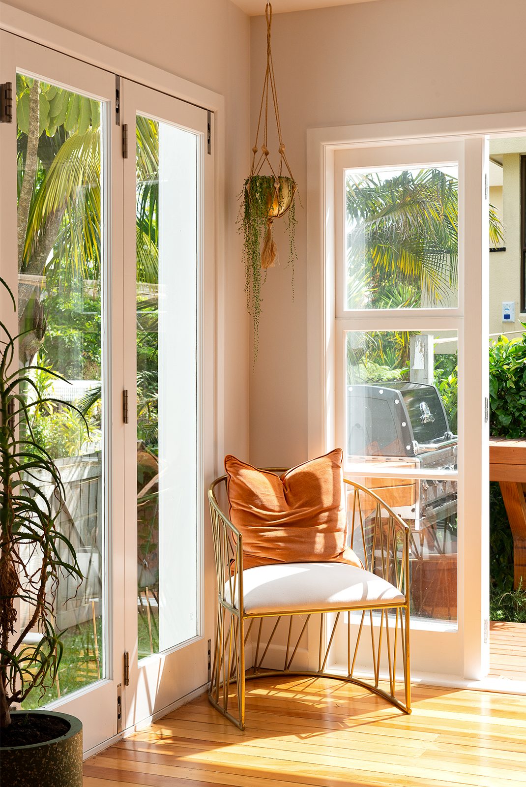 Mustard yellow chair in the corner of an open space room