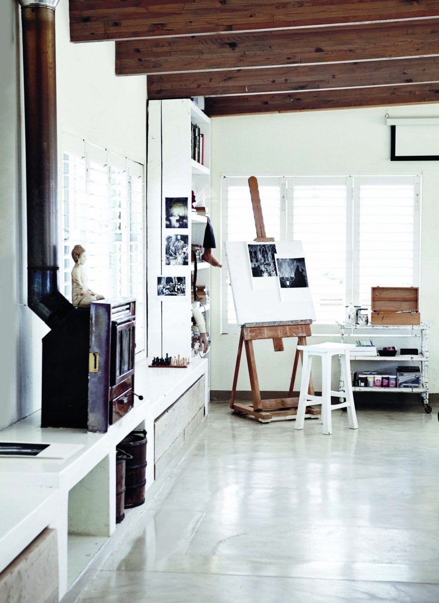 Living room with timber beams, grey floors and white cabinets