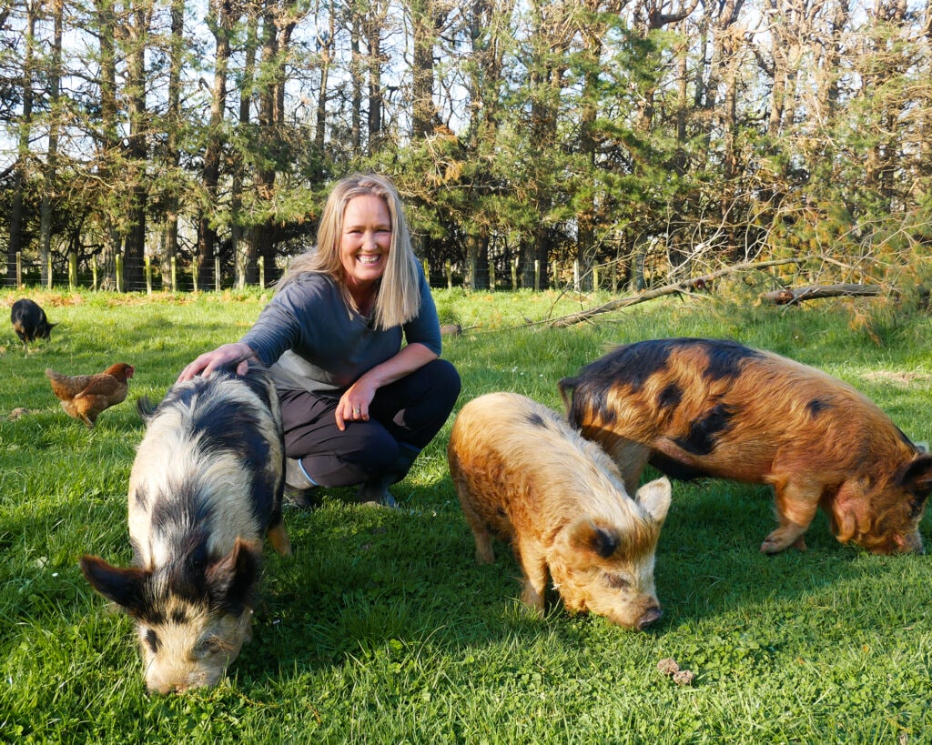 Katrina McClelland with three piglets