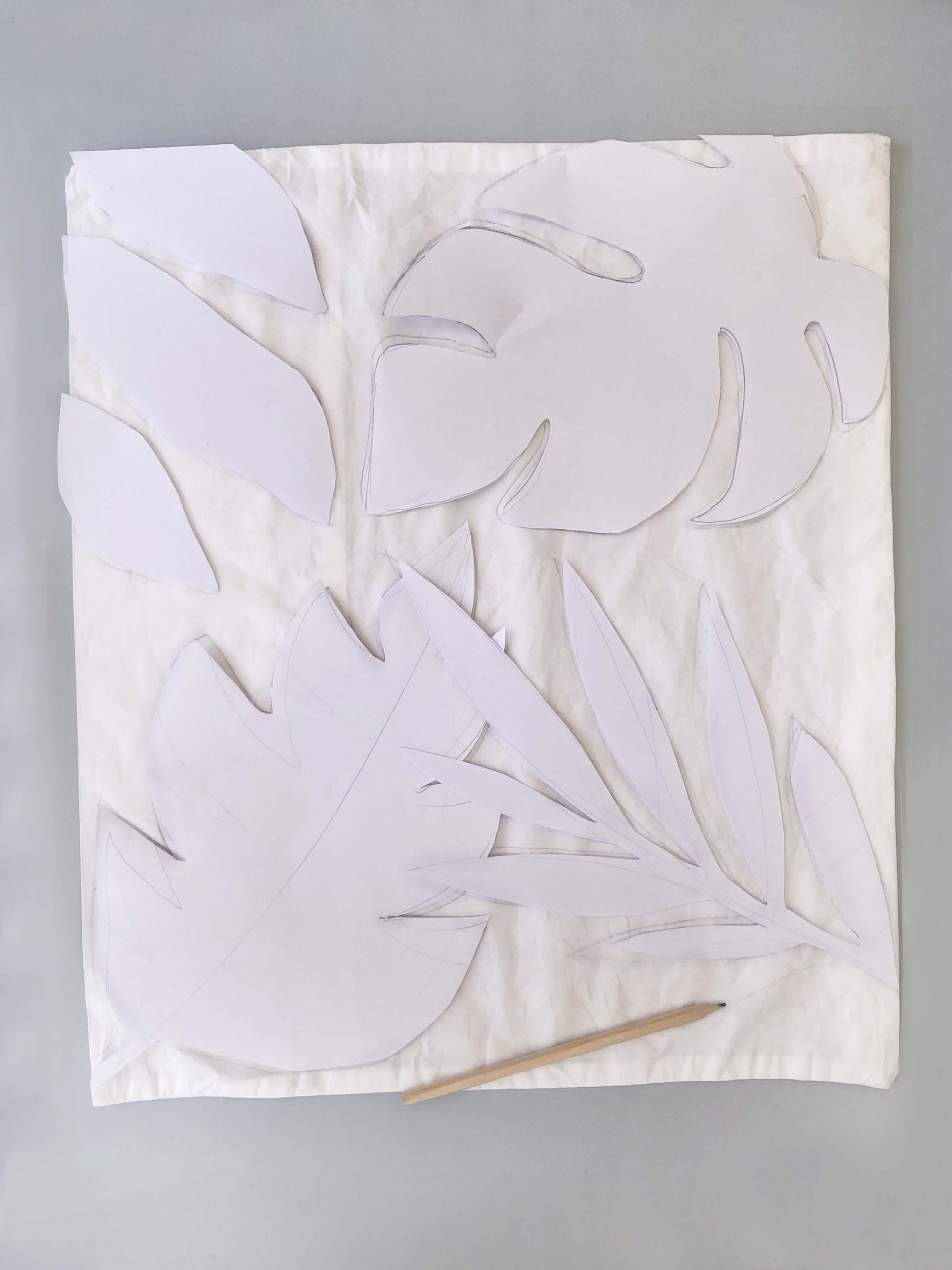 A white leaf cut out set on a white fabric 