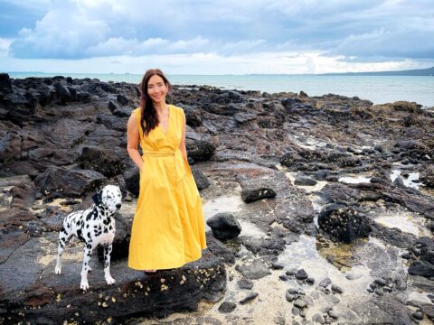 Dr Michelle Dickinson standing on rocks with her pet Dalmatian Noodle