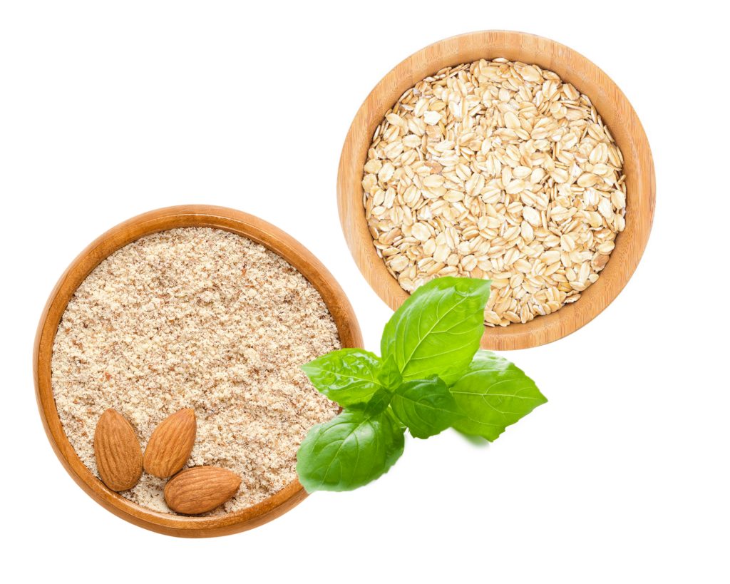 Two exfoliants on a white background with a piece of mint on top