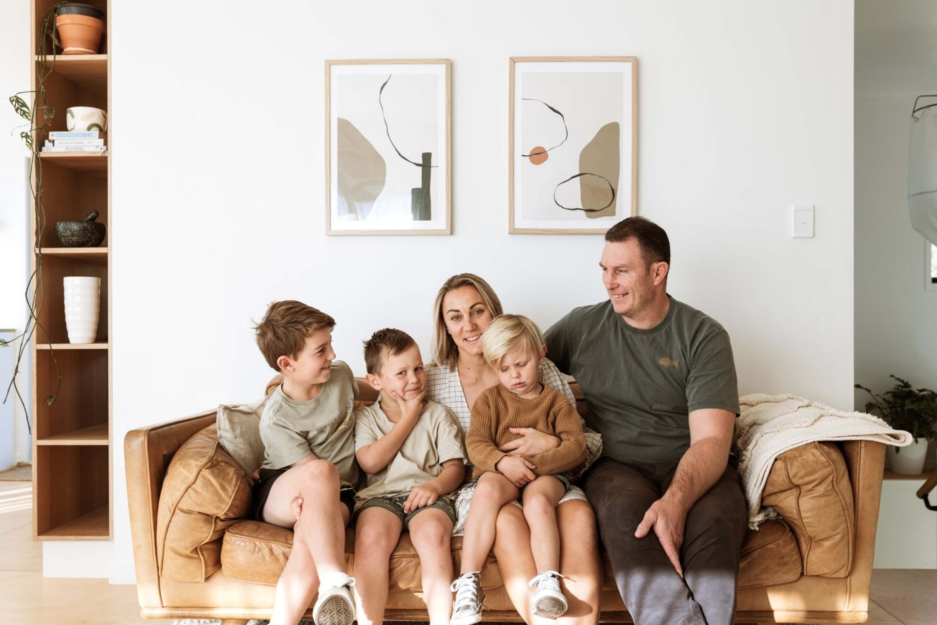 Debbra Sweetman, Mitchell Sweetman and sons Archer, Bodin and Vann sitting on a brown leather couch