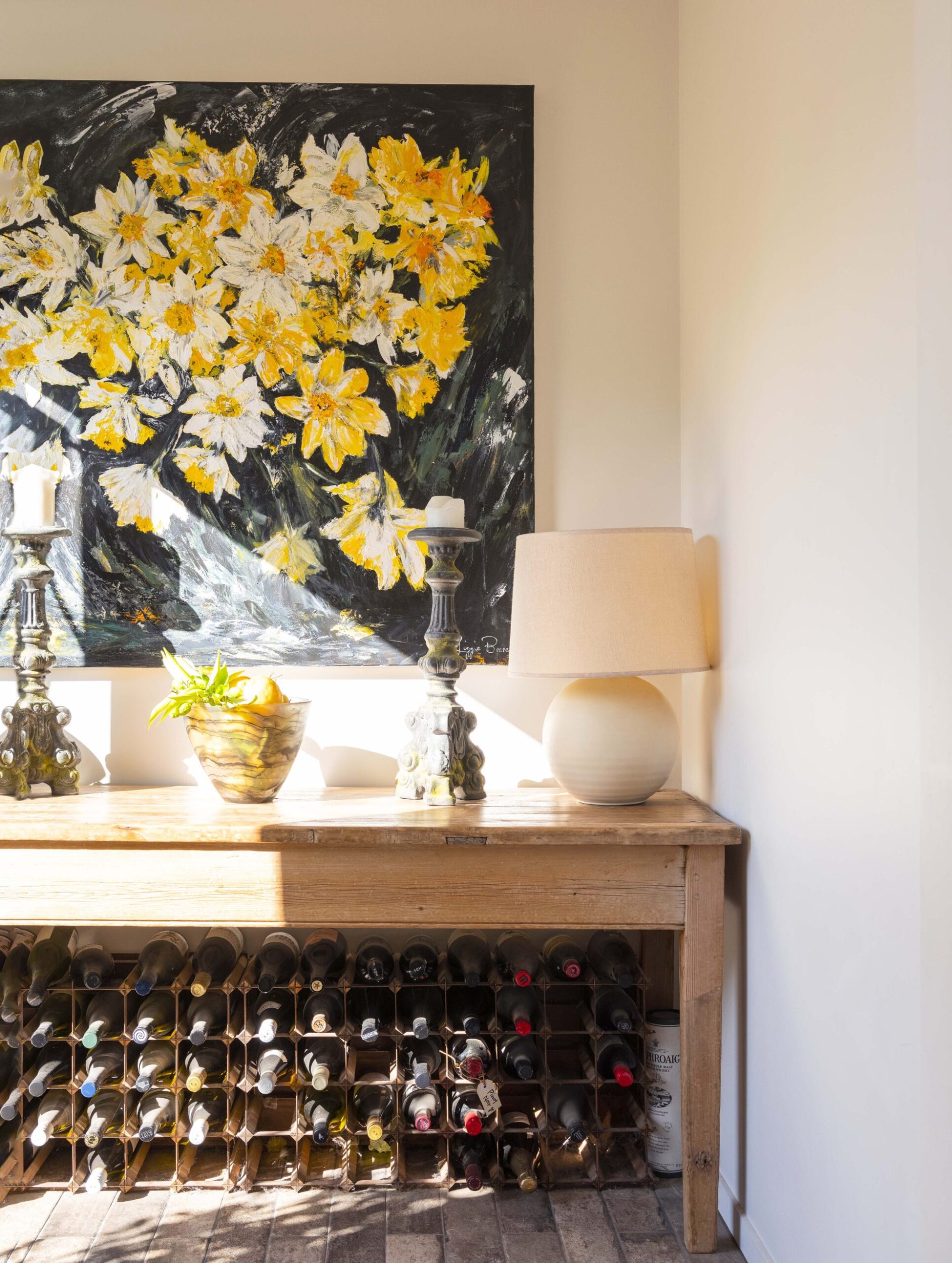 A large black and yellow floral artwork by Lizzie Beere hanging on wall