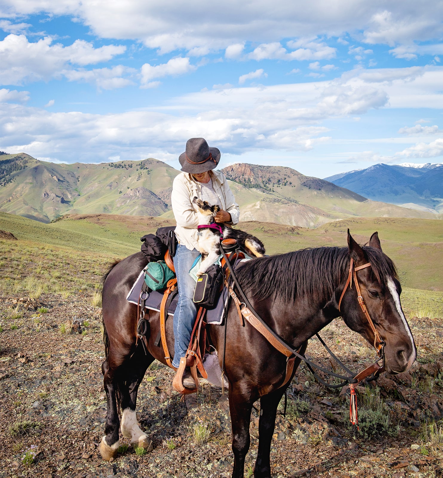 Nicole Masters on her horse holding her dog