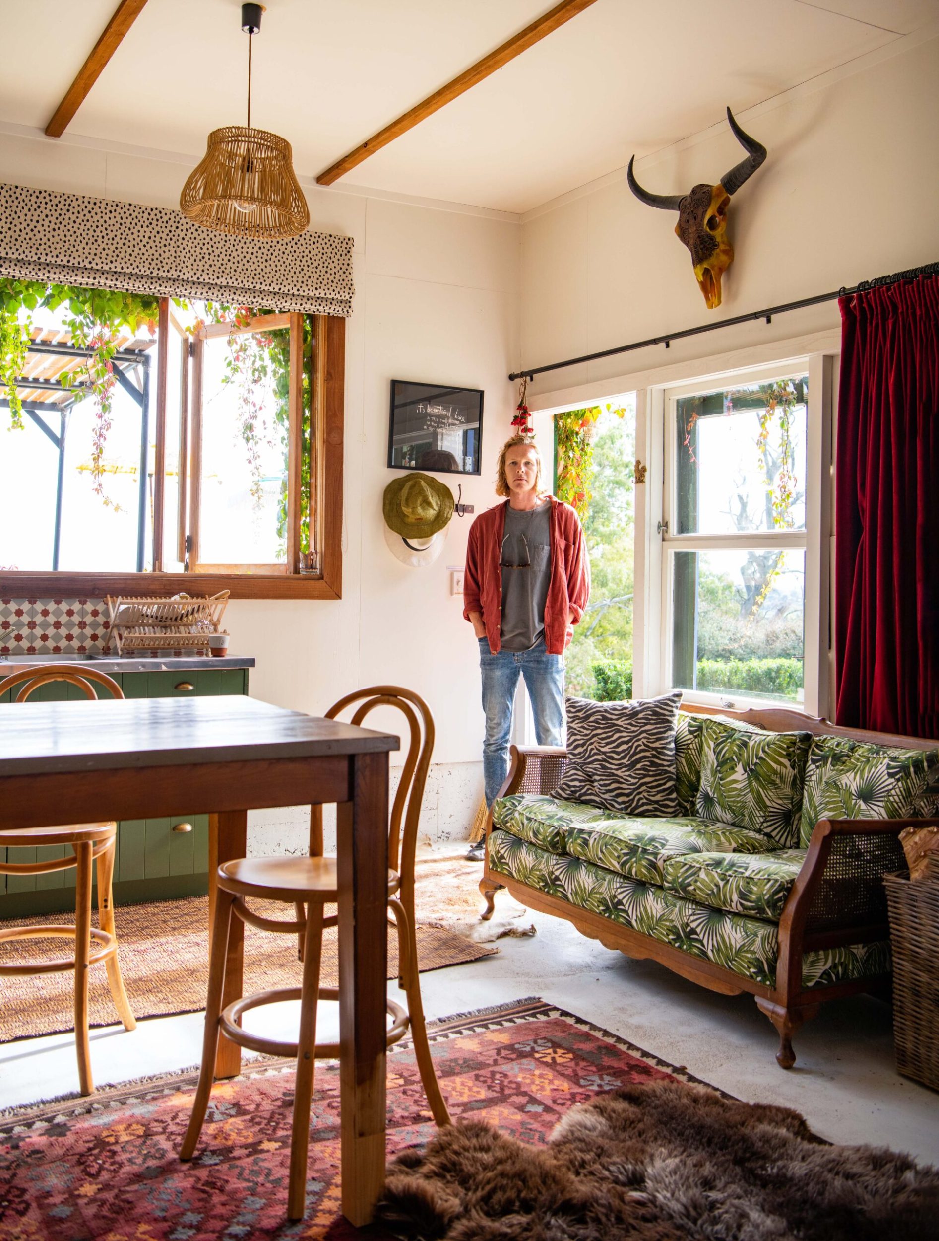 George Gaddum standing in the living room at Tiger House 