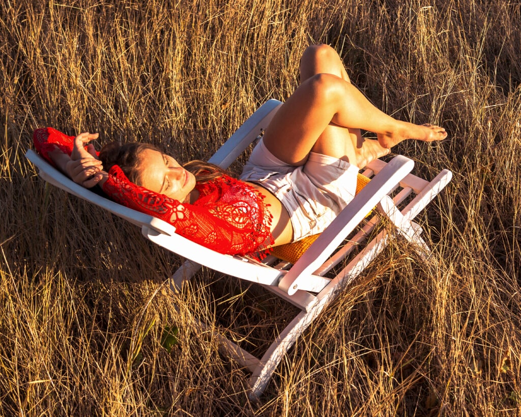Woman sleeping on red hammock