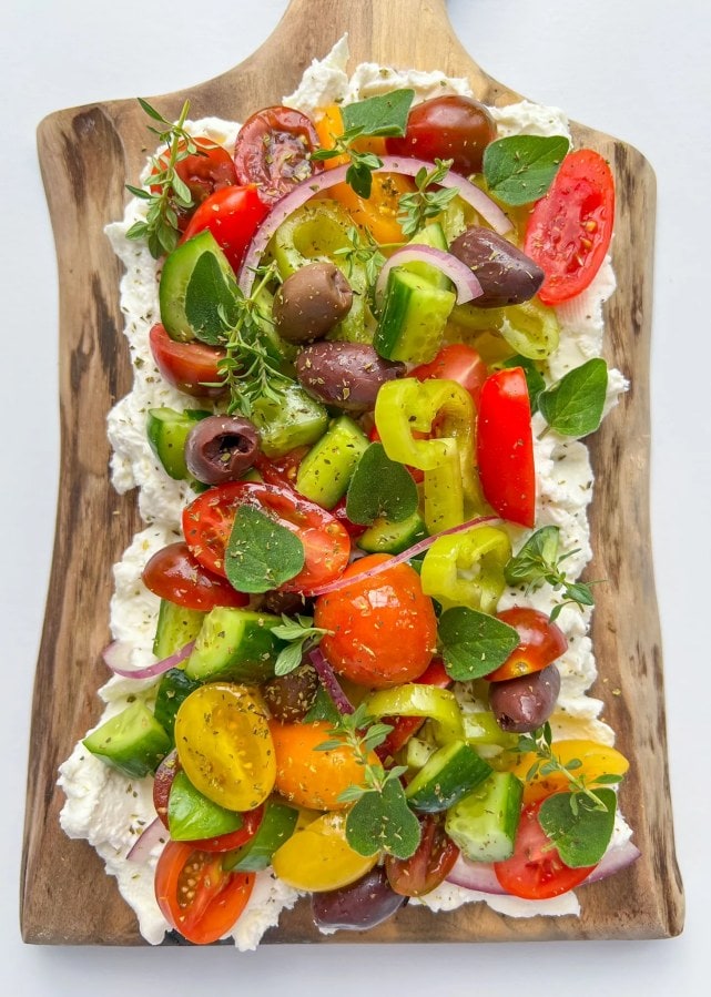 the best butter boards have peppers, olives, herbs and cottage cheese. 