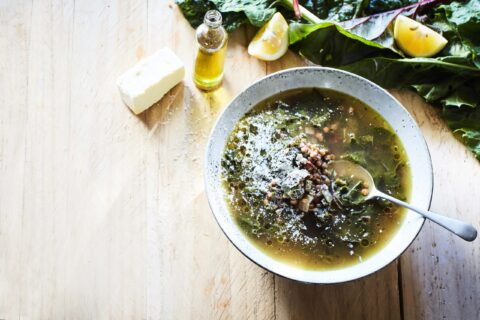 Greens, garlic, lemon and lentil soup in a bowl