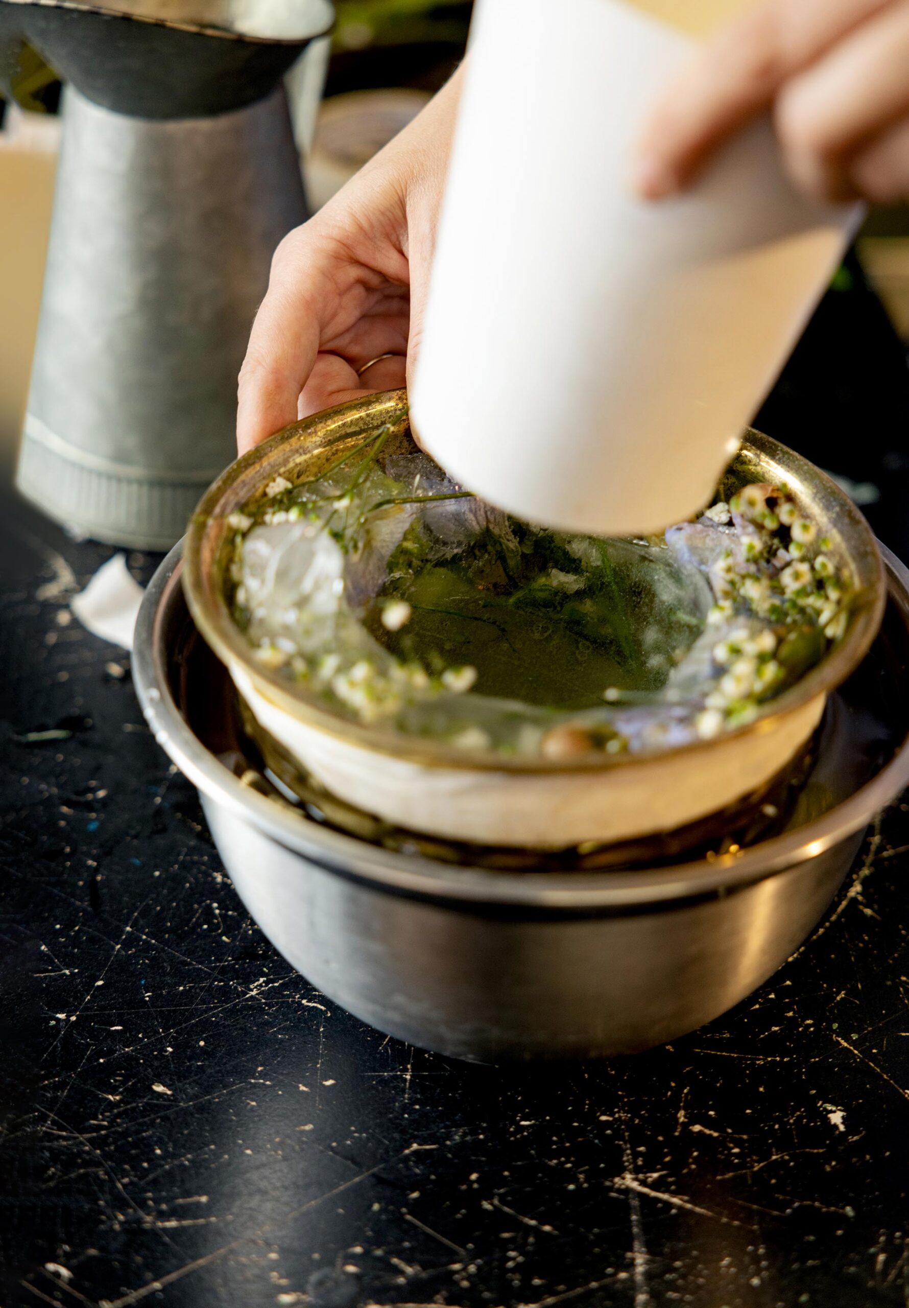 Removing the smaller container filled with rice from the larger ice bowl