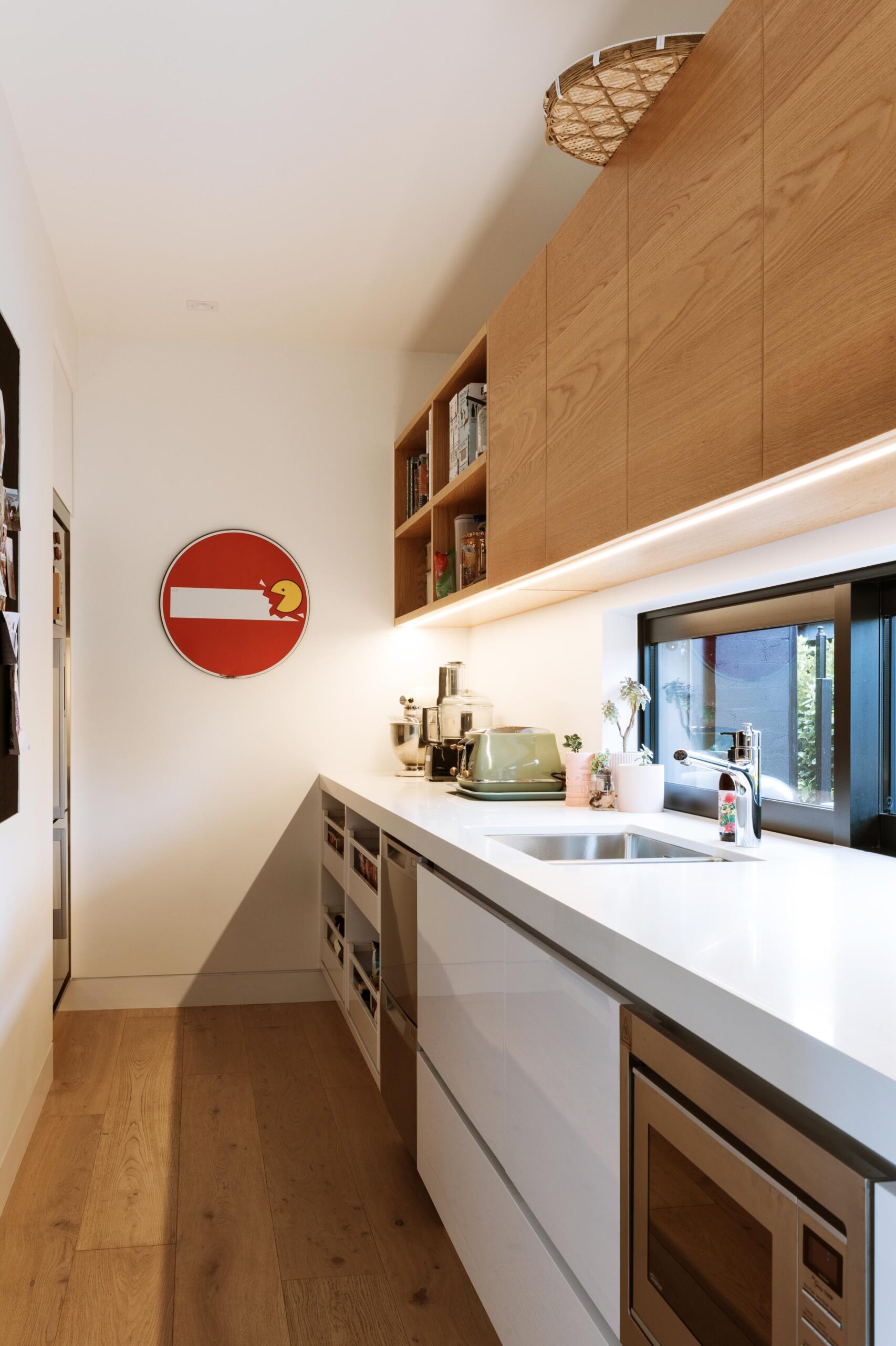 A kitchen scullery with sink and appliances.
