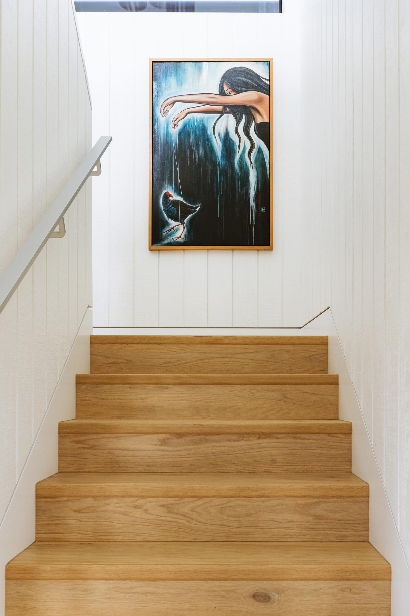 Wooden stairs lead up to a dark painting.