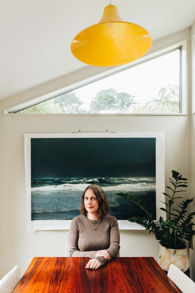 Jess harkins in front of a huge ocean painting