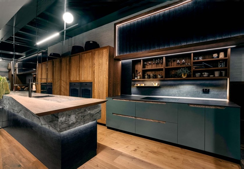 dark black kitchen with open shelves and black cabinets with black bench and black marble splashback 