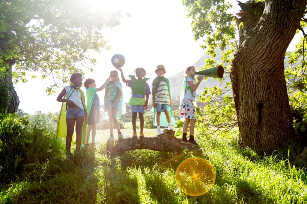 a group of children playing with props outside