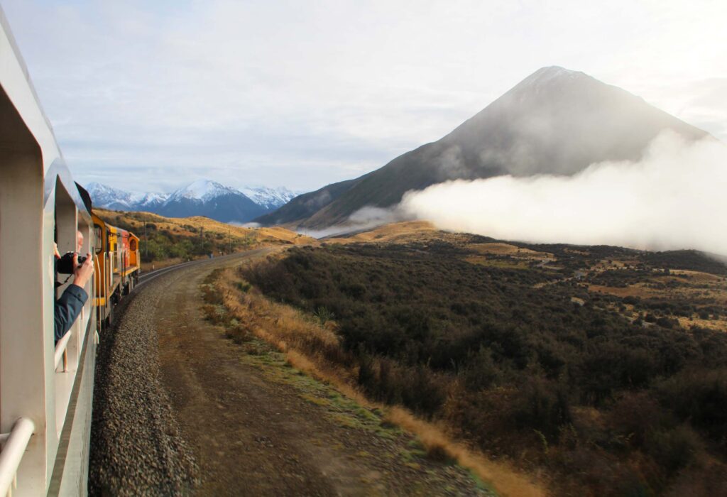 a train travelling towards a mountain