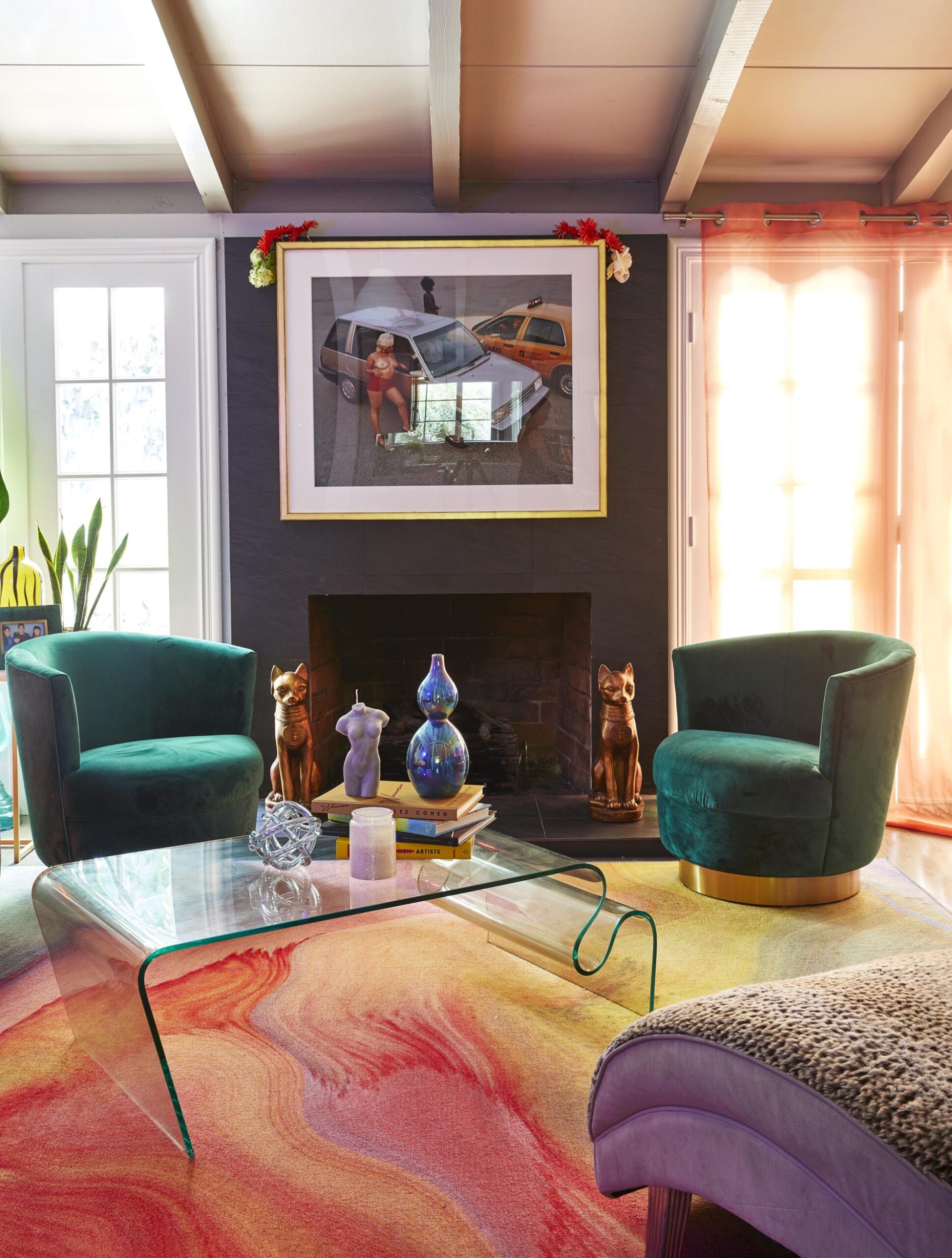 Parris Goebel living room  with colourful technicolour carpet, green velvet seats and cat decor 