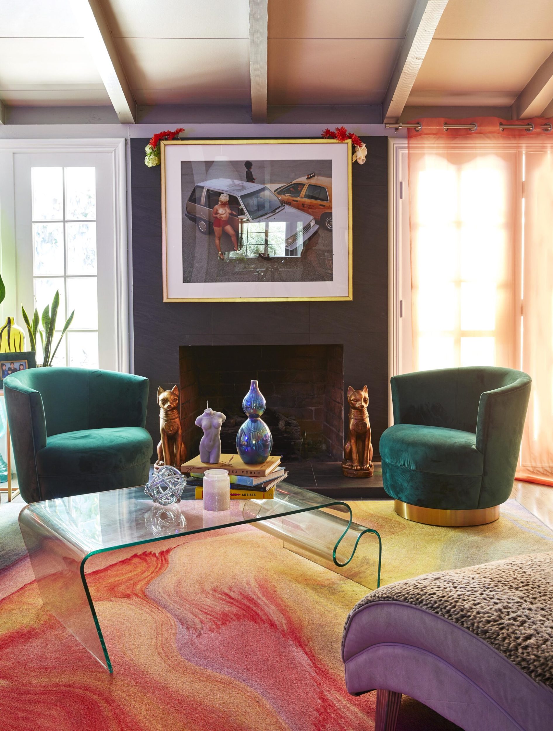 Parris Goebel living room with colourful technicolour carpet, green velvet seats and cat decor