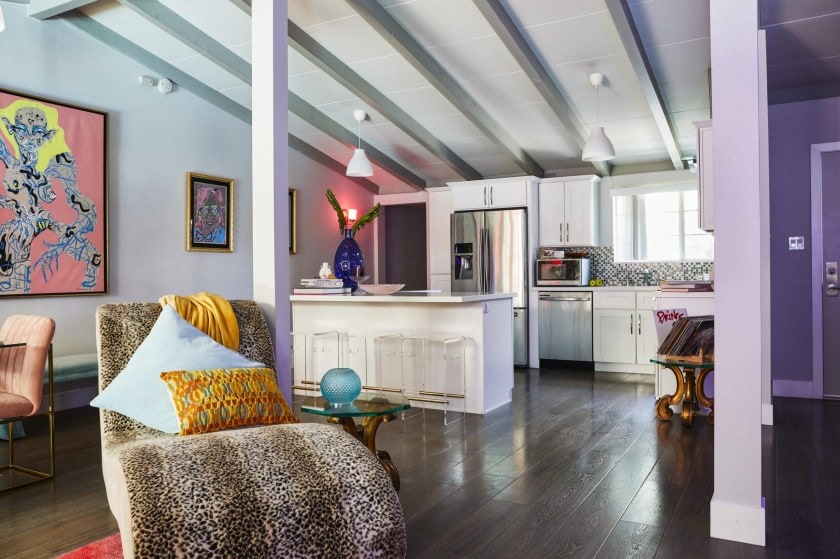 Parris Goebel's kitchen with polished wood floors, ceiling beams and leopard print seat
