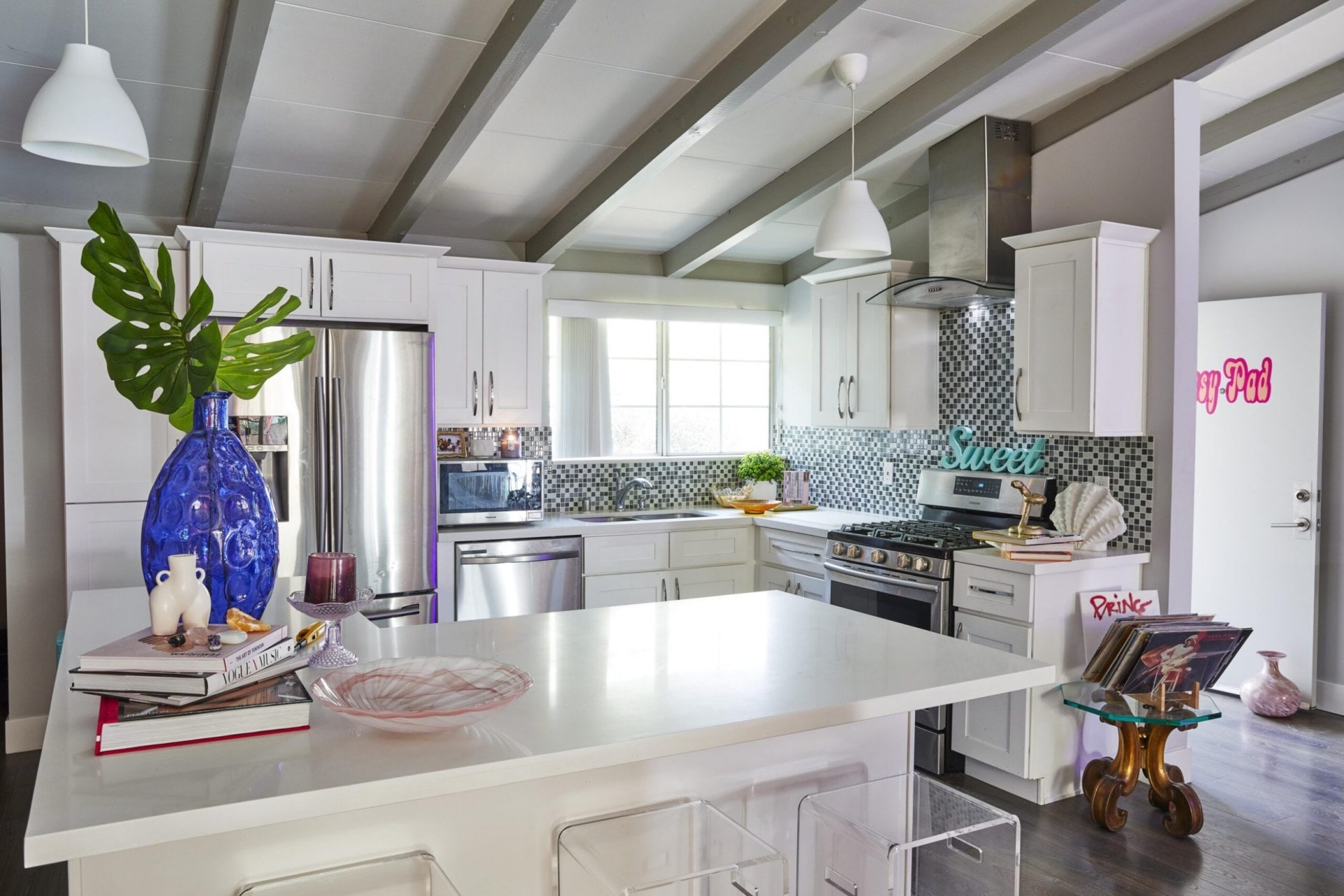 Parris Goebel home kitchen with white marble benchtops, arched ceilings and checkered tile splashbacks