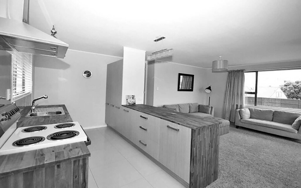 black and white photo of the kitchen and living room