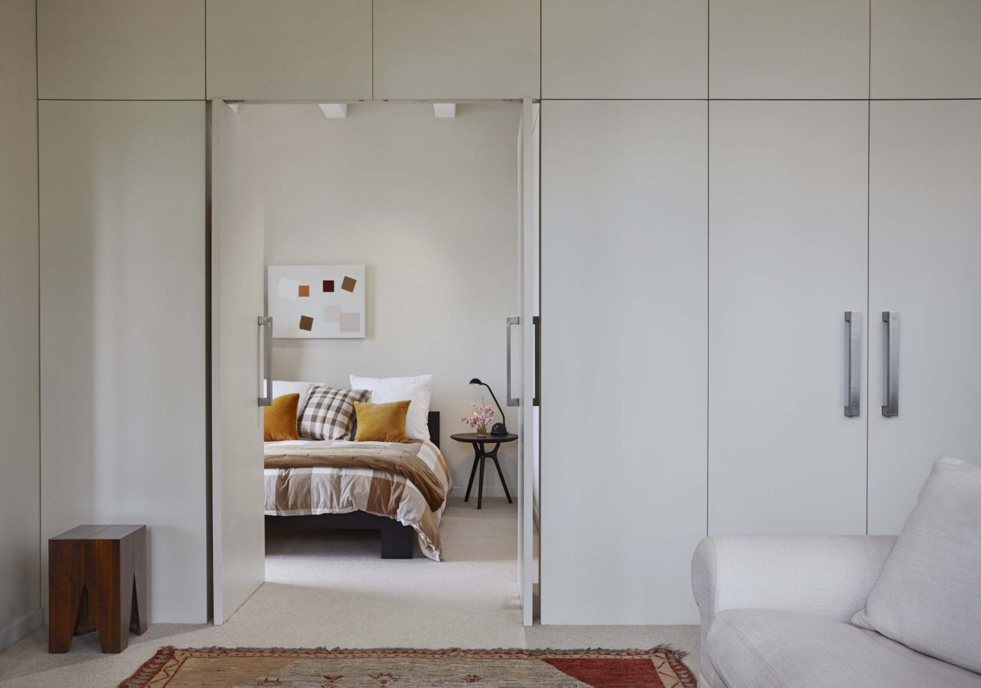 White bi-fold doors that open into a bedroom