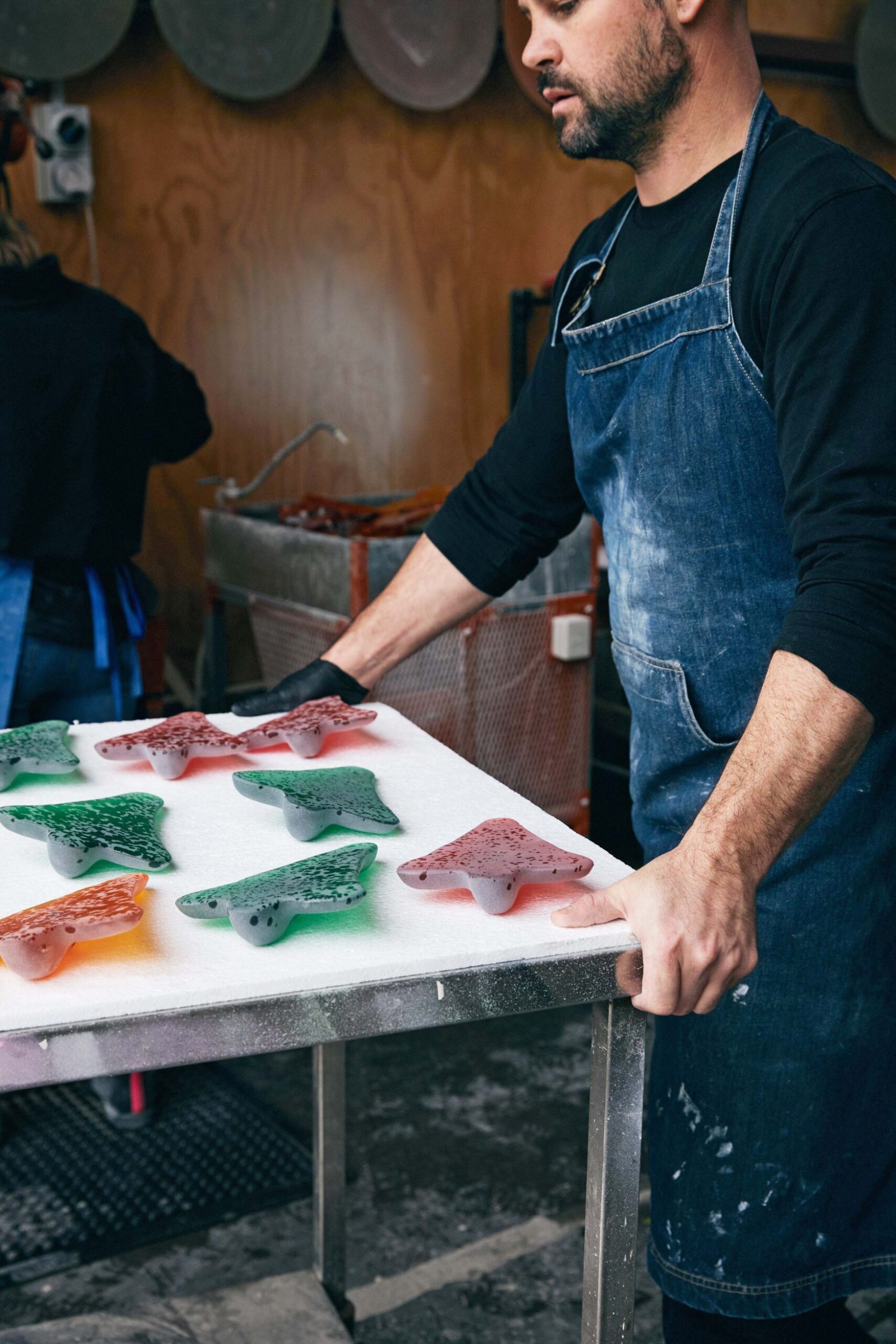 Simon Lewis Wards in his studio working on his glass giant jet plans