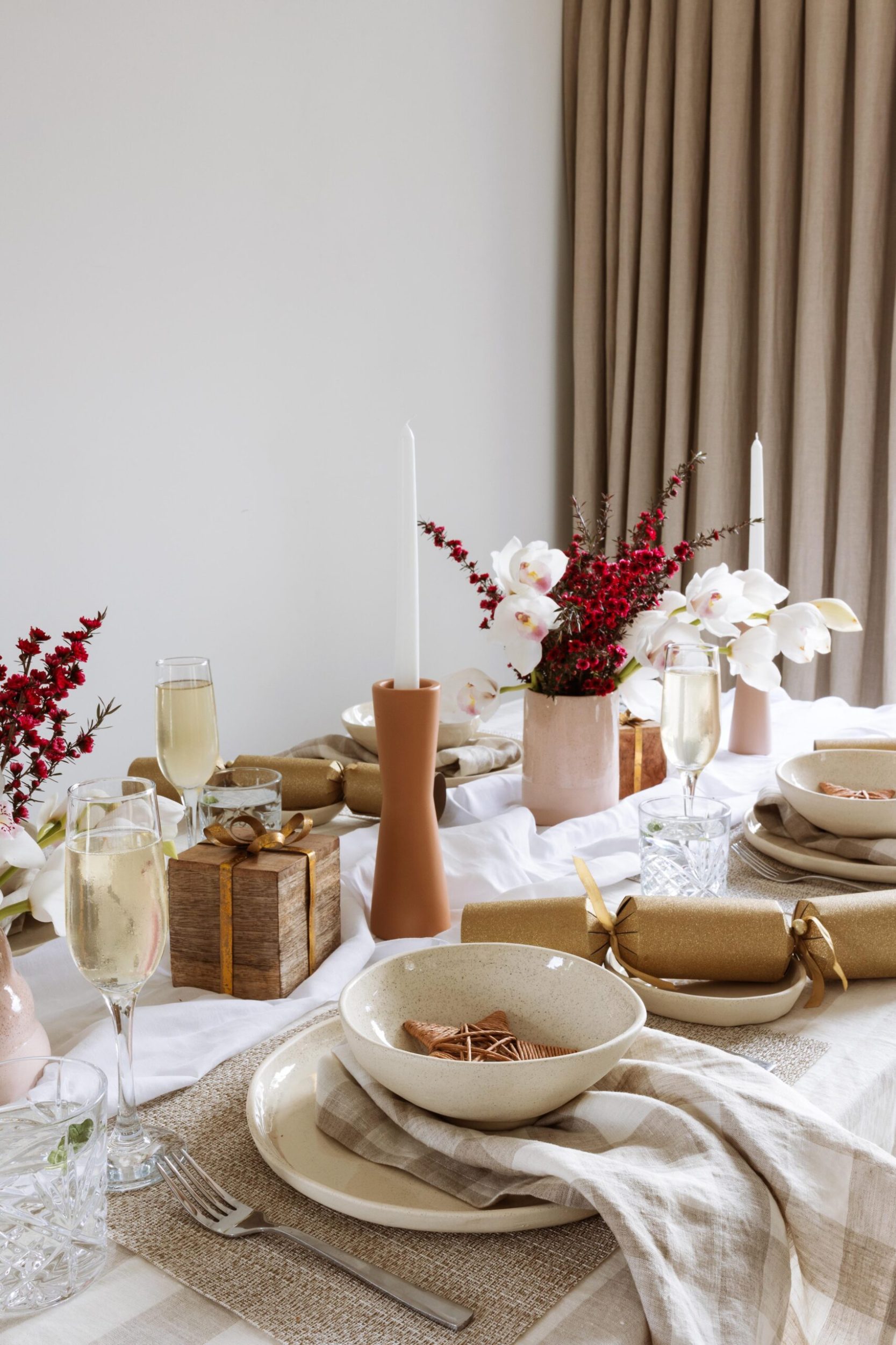 Cherie's dining table dressed for a meal with white and natural linens and terracotta candle holders
