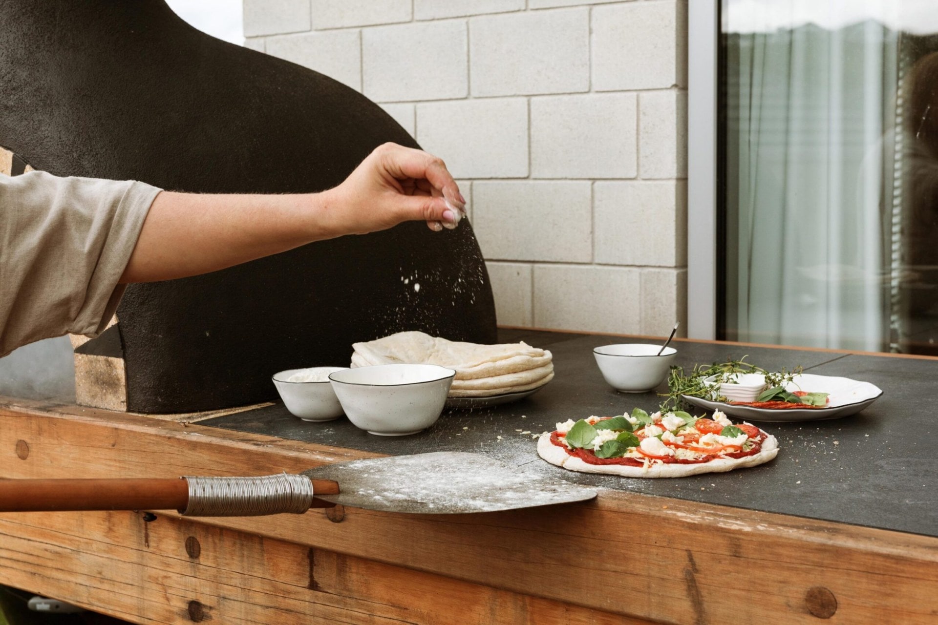 Cherie making a pizza in one of her two pizza ovens