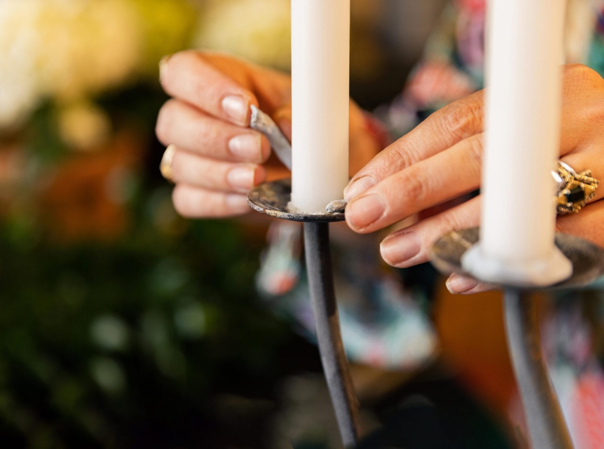 Georgie Maylon attaches a candle to the candelabra with blu-tak