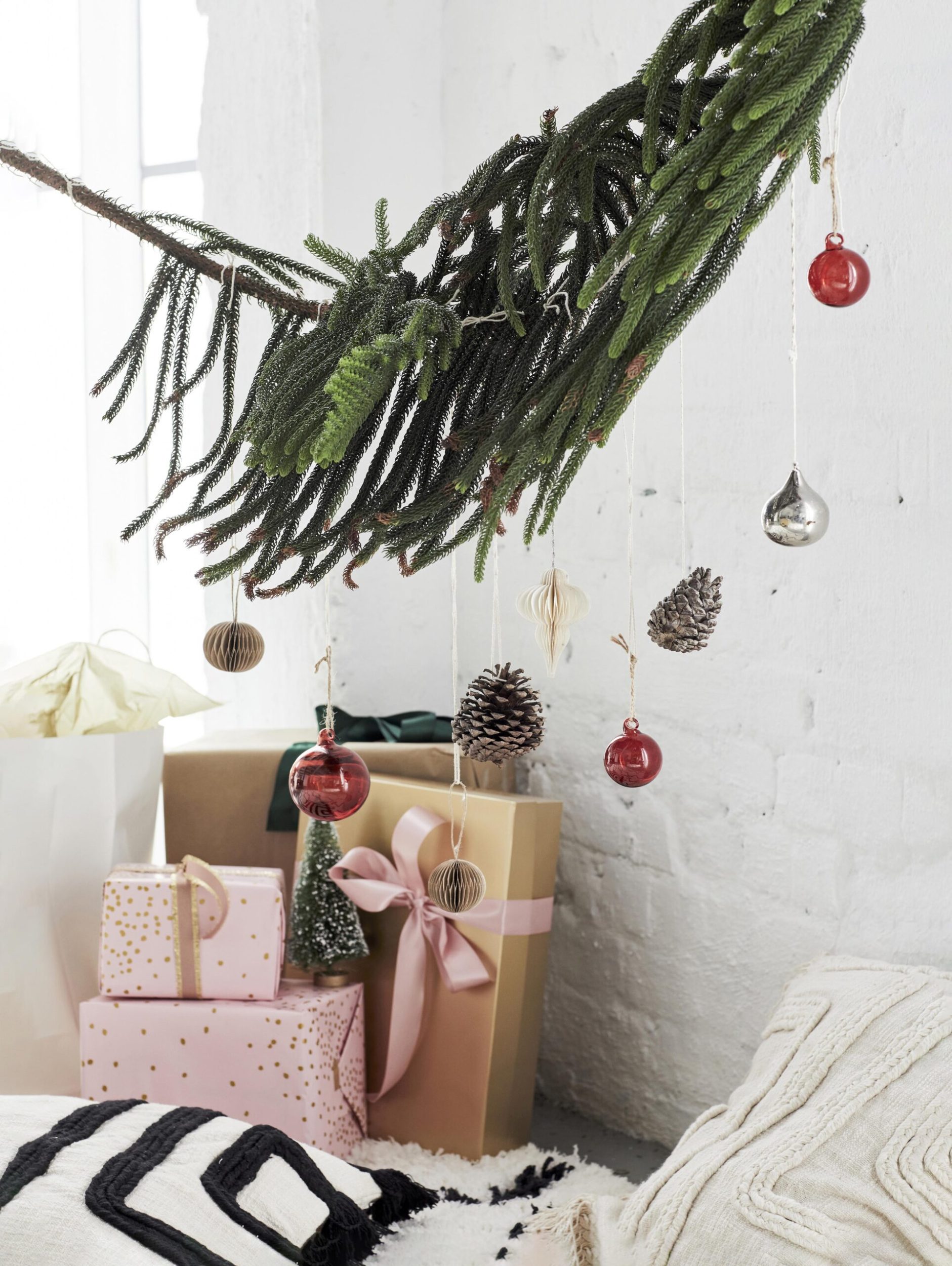 gold and blush wrapped presents under a tree branch