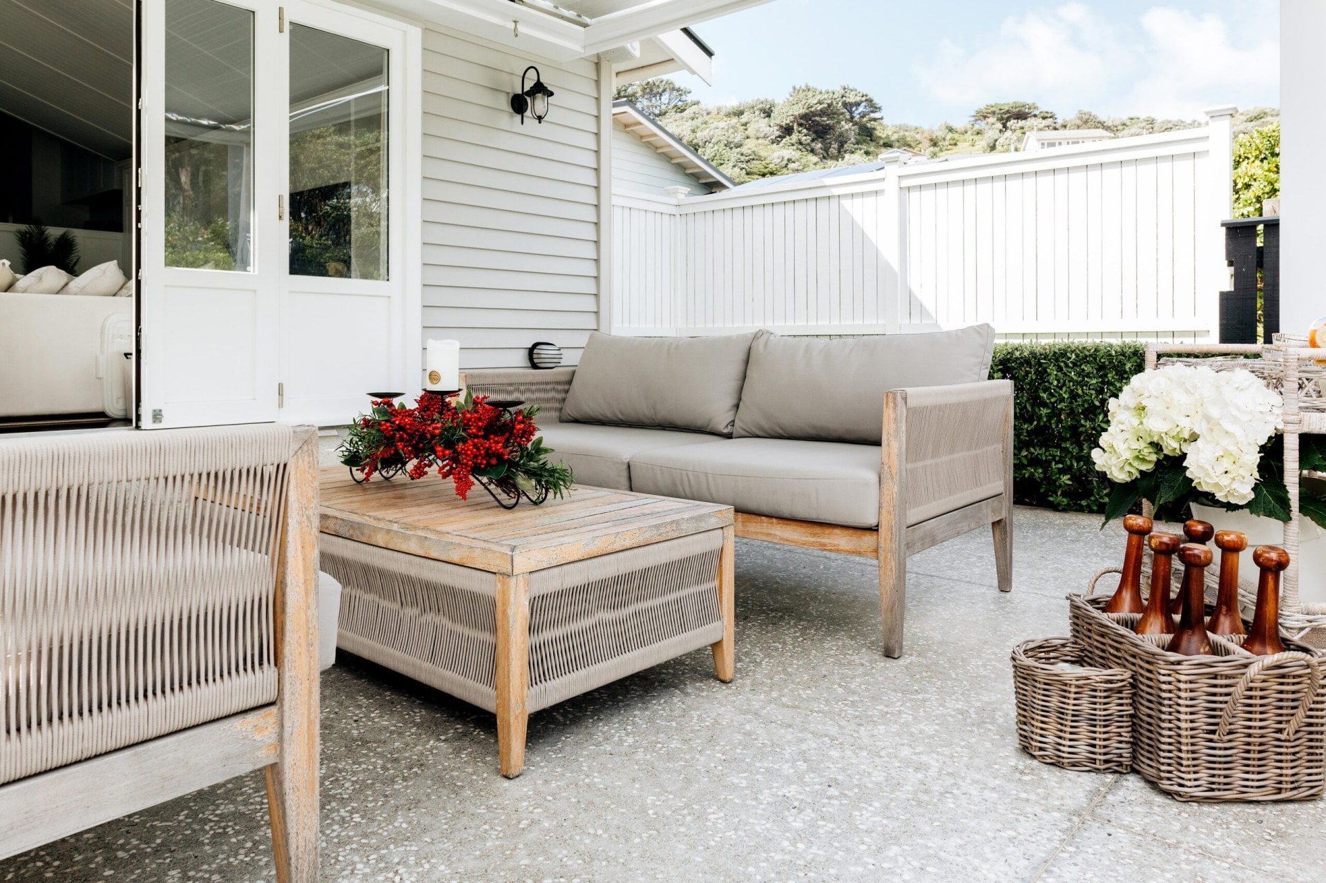 Paved outdoor area with two outdoor and wicker sofas