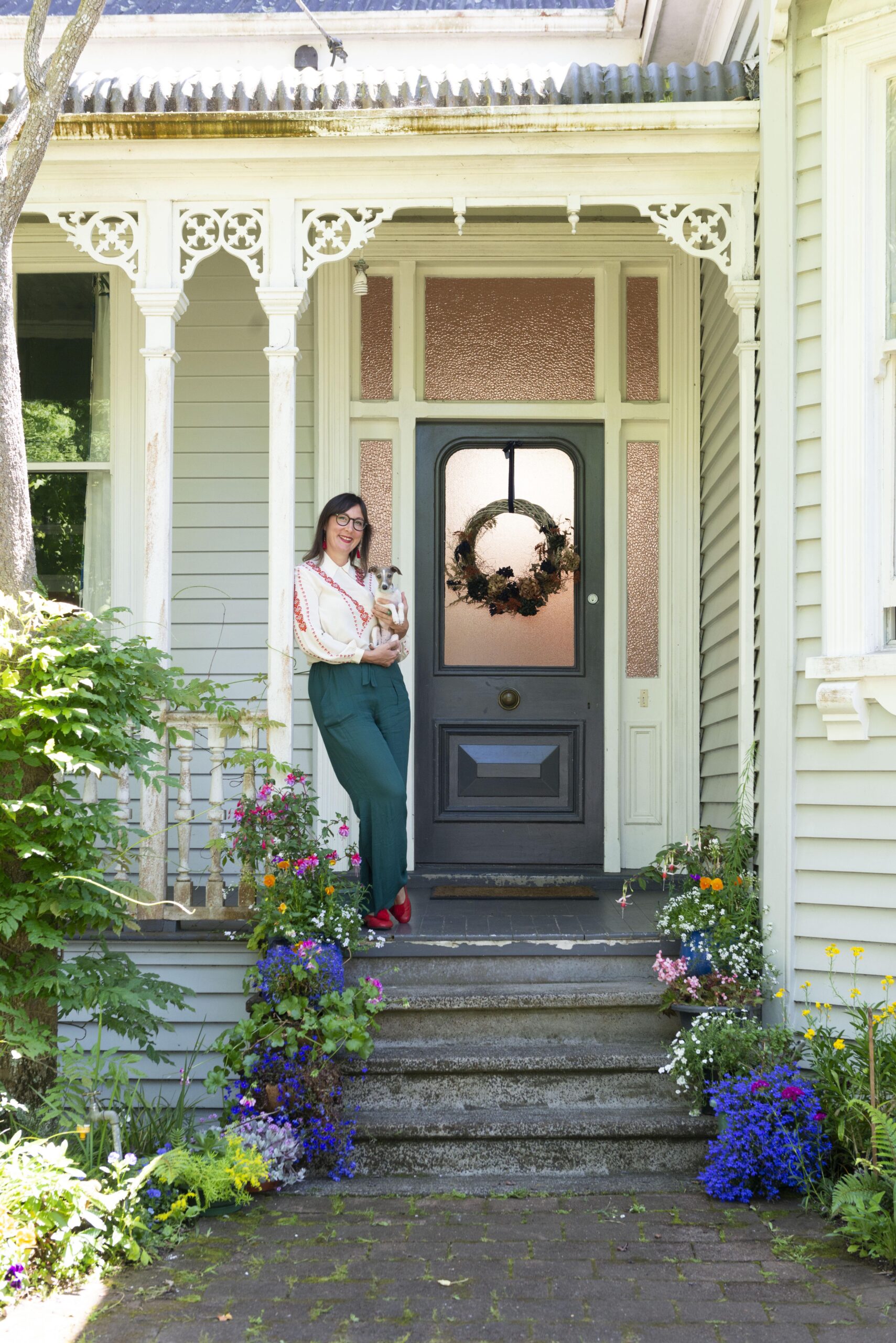 Rose Jackson standing outside her grey front door