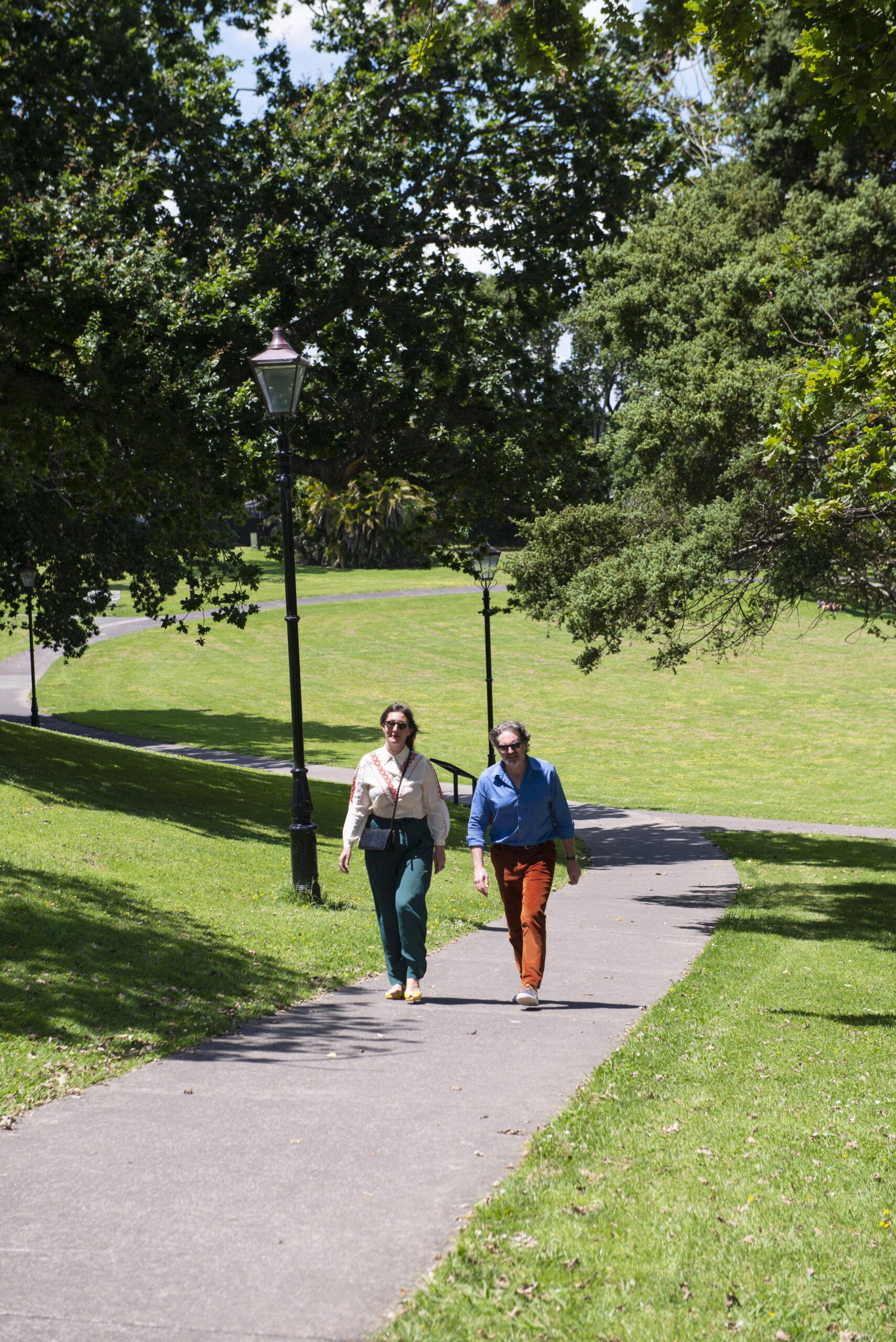 Matt Wiseman and Rose Jackson walk in a green space in Mt Eden