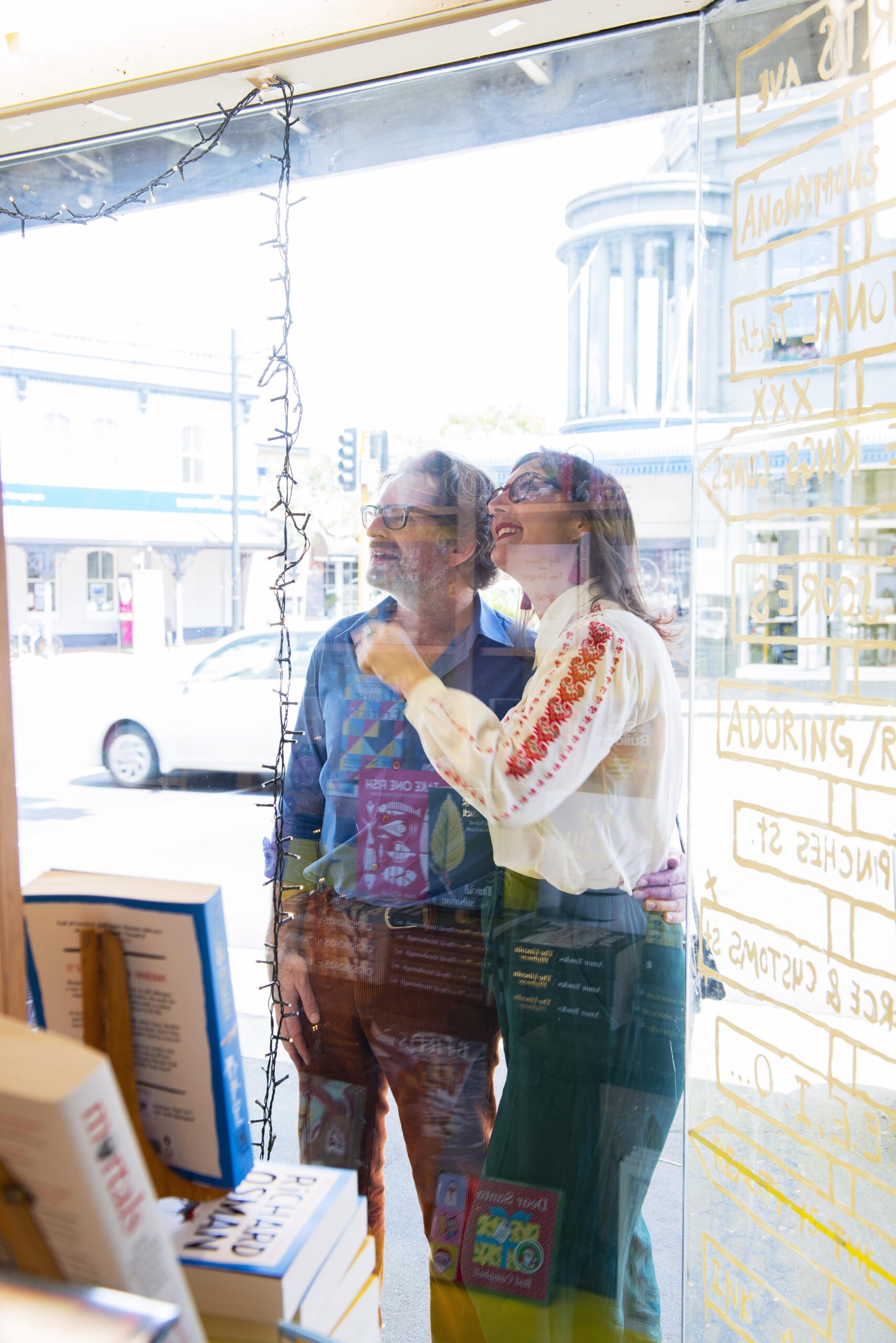 Rose Jackson and Matt Wiseman look through a window