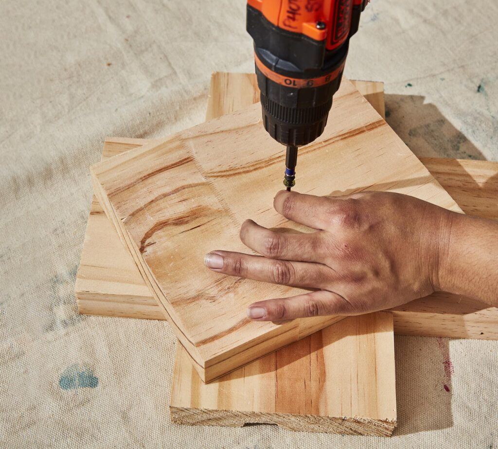 screwdriver screwing two pieces of wood together