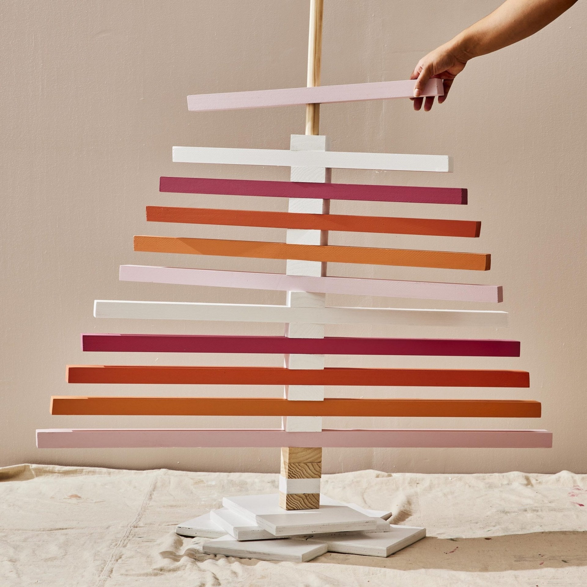 wooden planks attached to a base to create a christmas tree