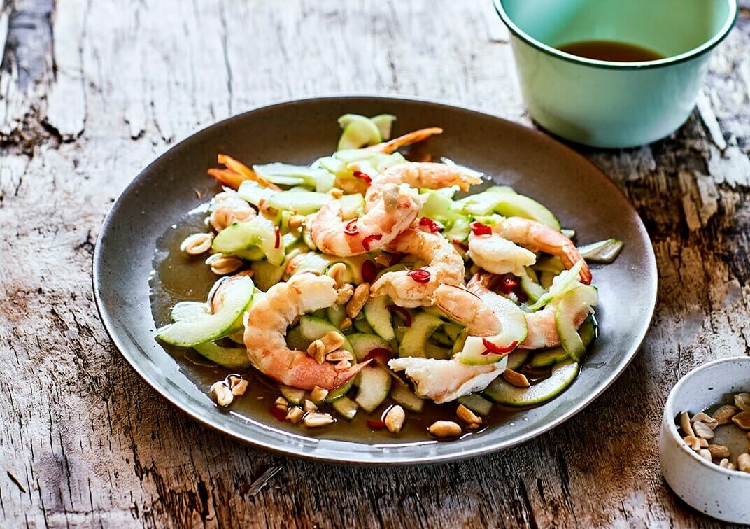 Hot and sour prawns and cucumber on a black plate