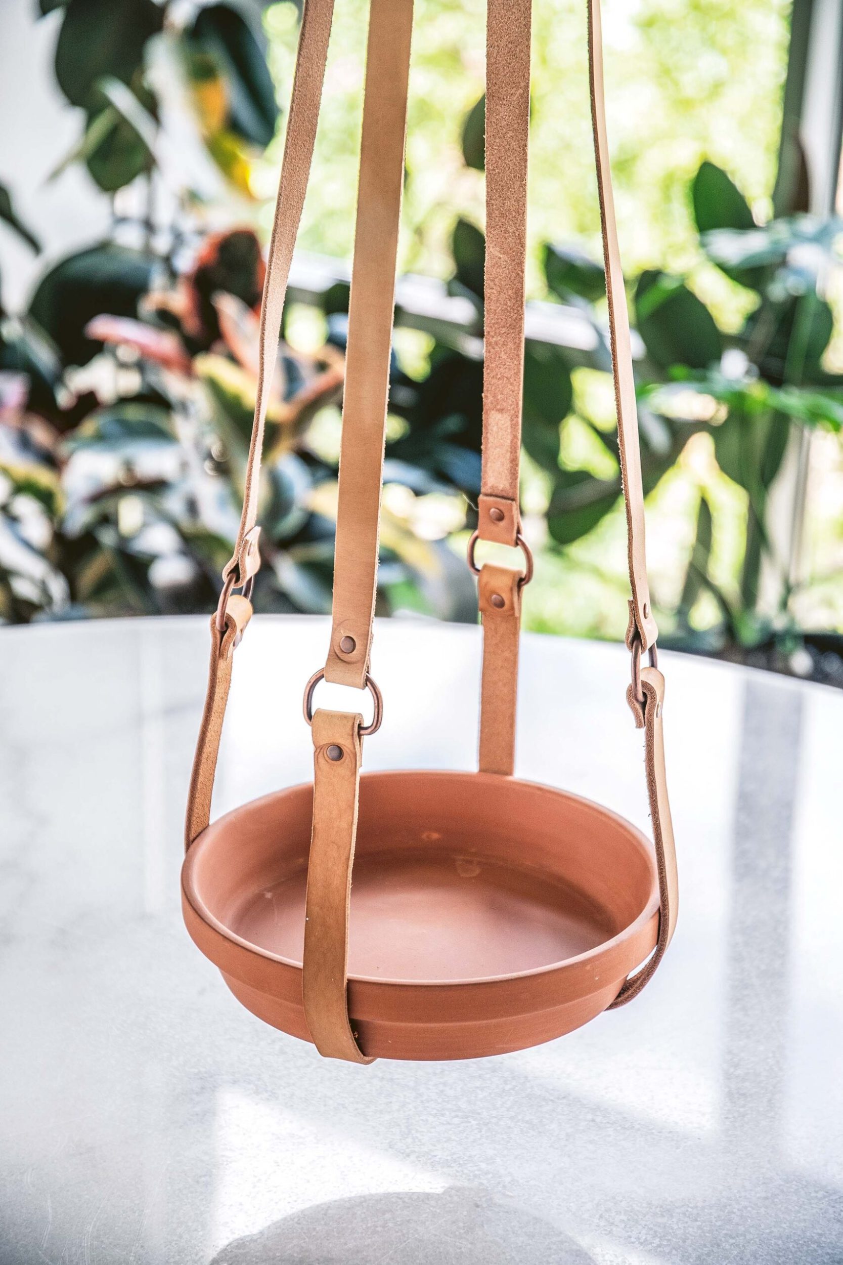 Hanging planter with leather straps and ceramic plate