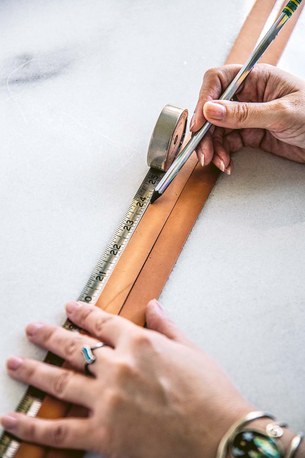 Measuring a line on leather straps with measuring tape