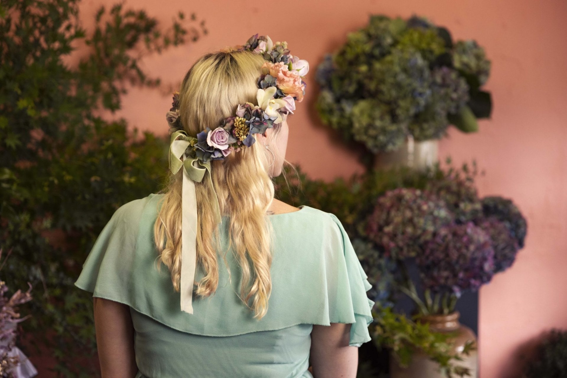Georgie Malyon with her back to the camera wearing flower crown