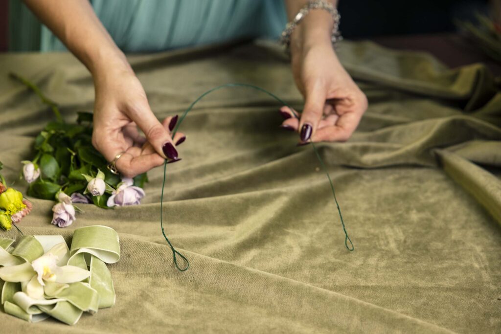 Hand holding wire for a flower crown