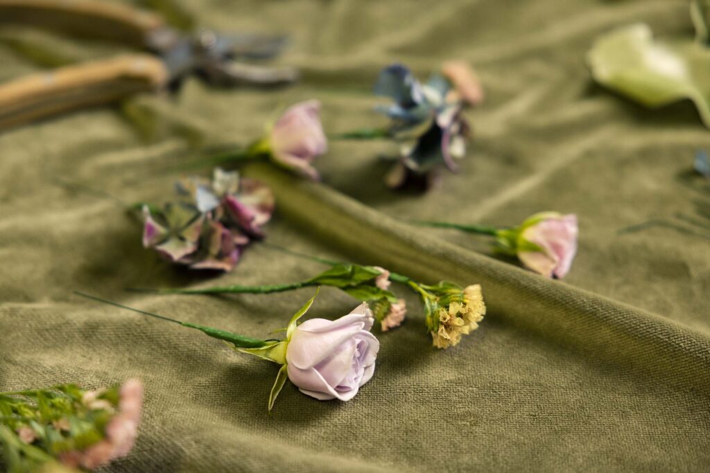 purple and yellow flowers laying on a velvet cloth